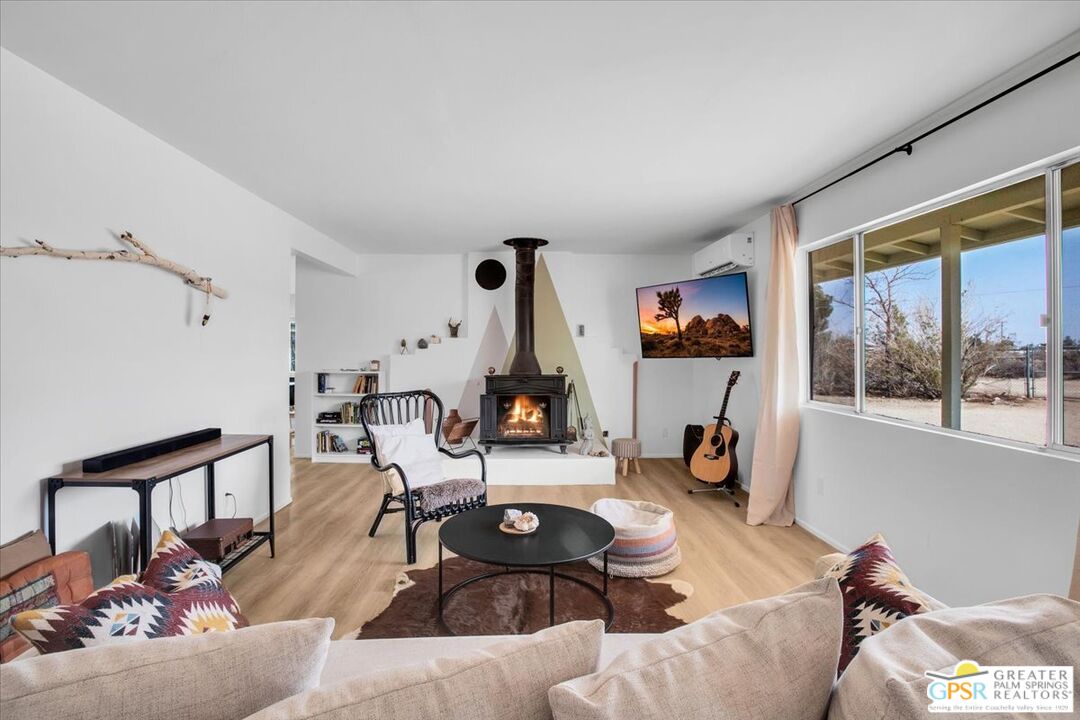 a living room with furniture a window and gym equipment