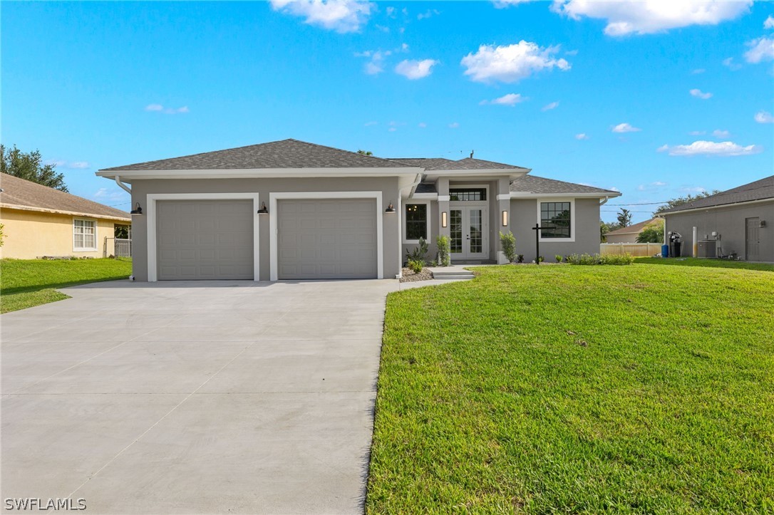 a front view of a house with a yard and garage