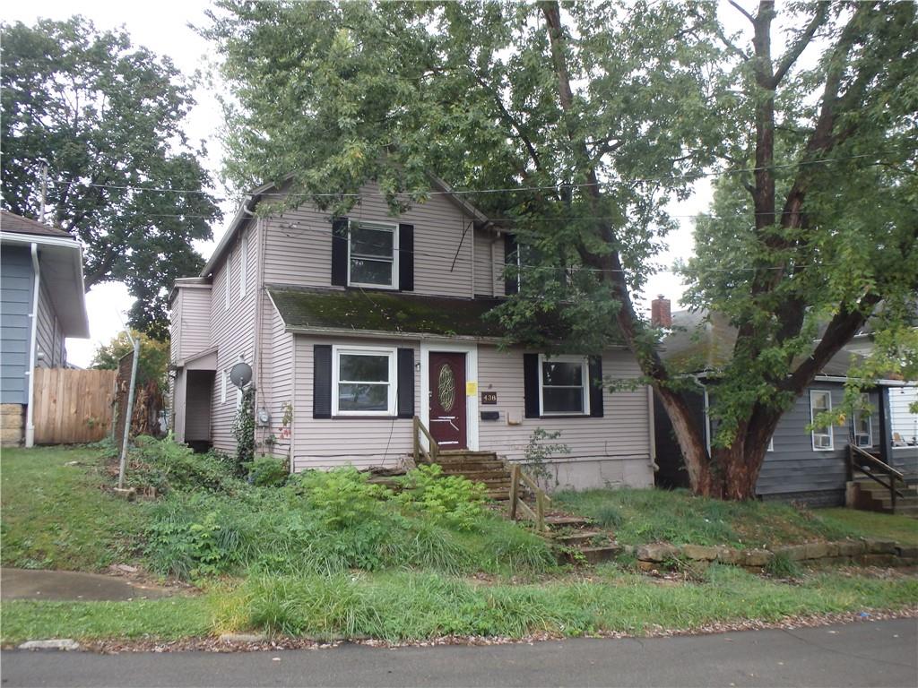 a front view of house with yard and trees