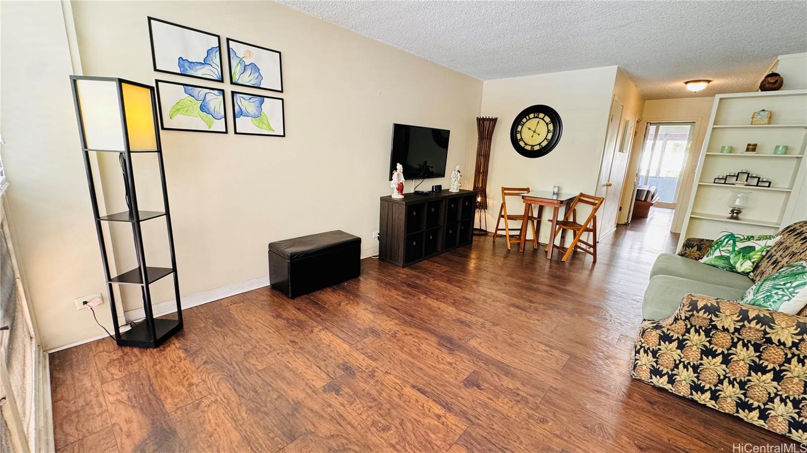 a view of a livingroom with furniture and hardwood floor