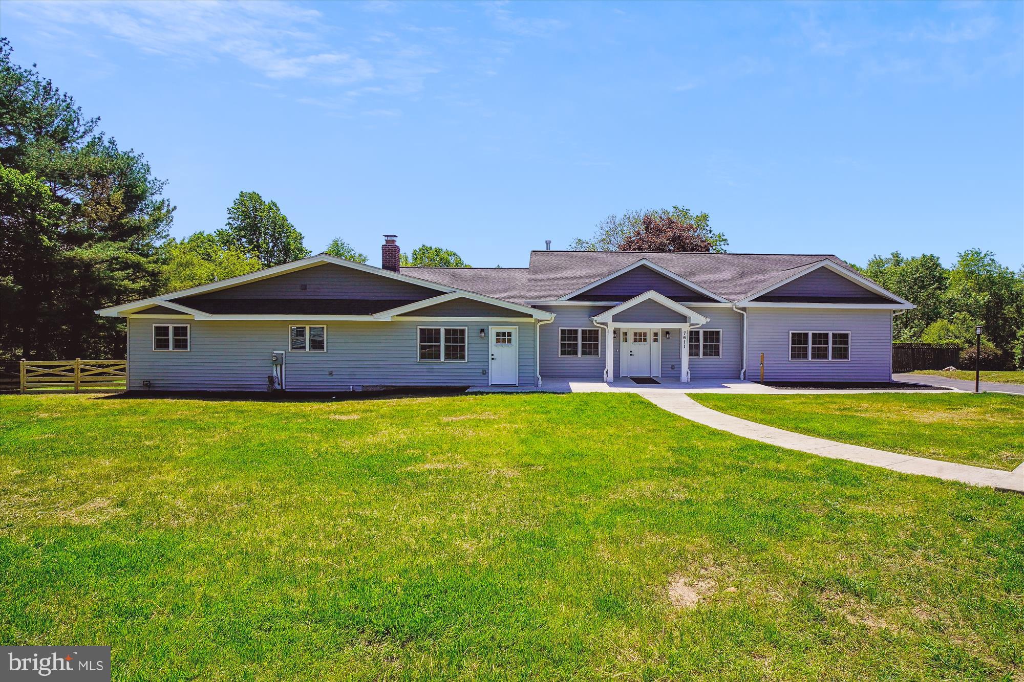 a front view of house with yard and outdoor seating