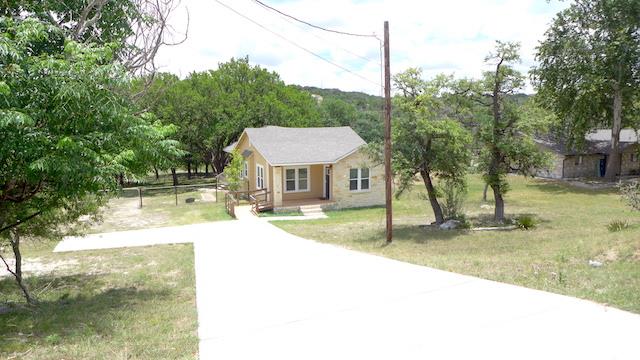 a view of a house with a yard and sitting area