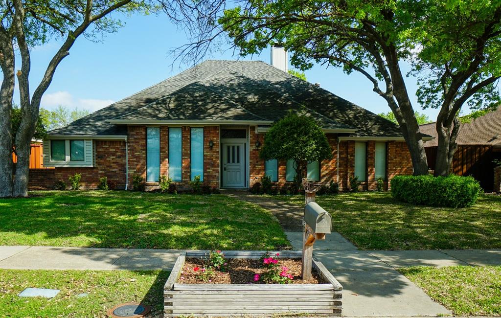 a front view of a house with a yard table and chairs