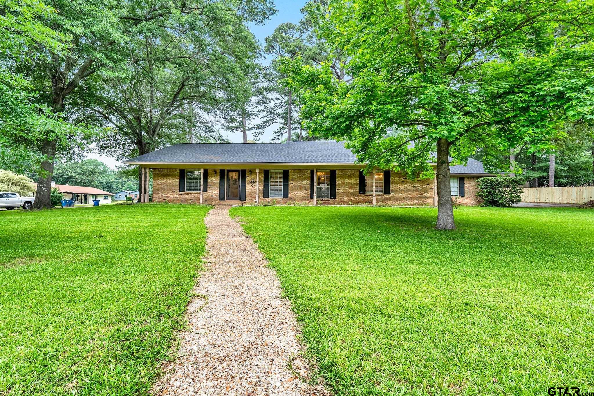 a view of a house that has a backyard