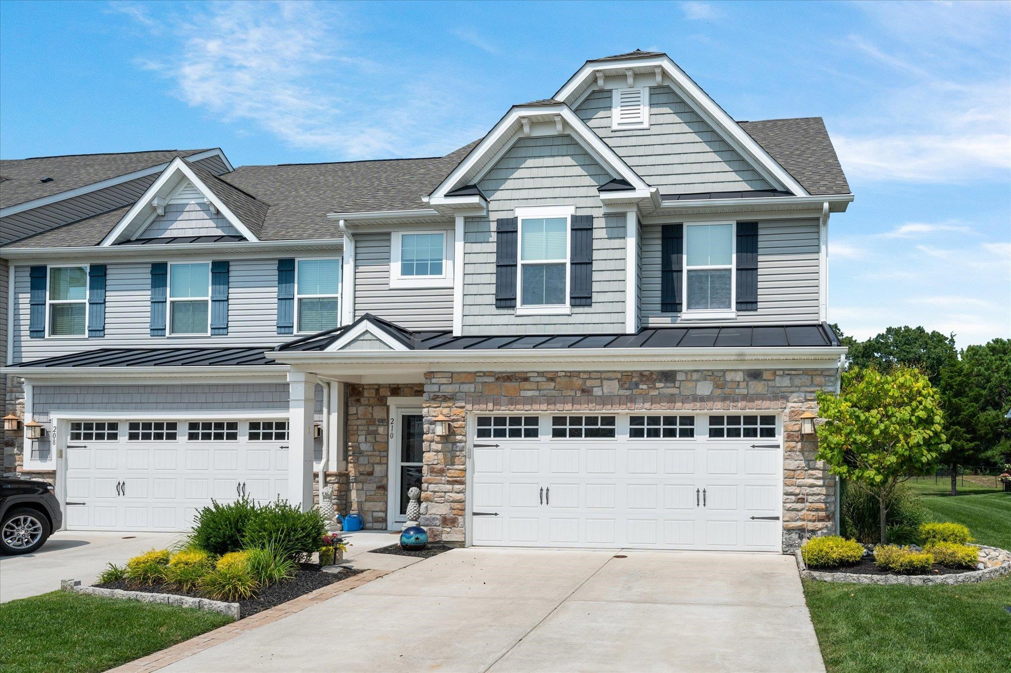 a front view of a house with a garden and garage