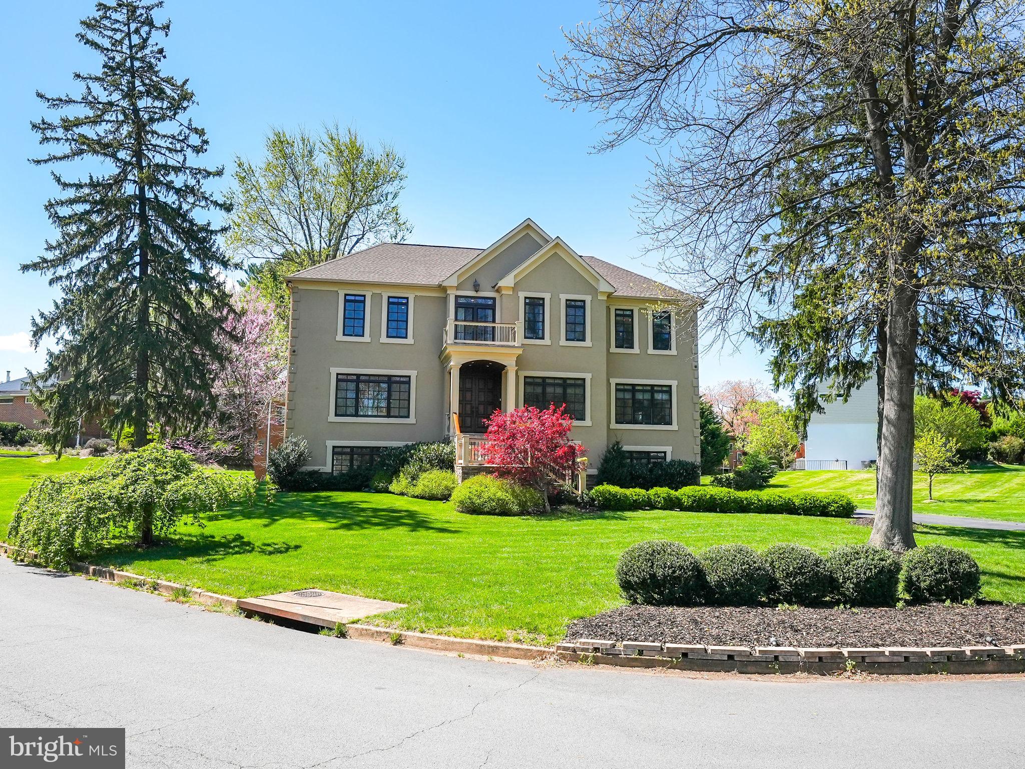 a front view of a house with a garden and plants