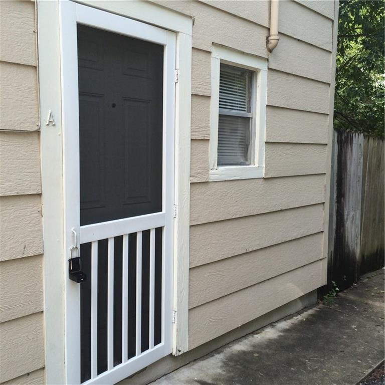 a view of a house with a wooden fence