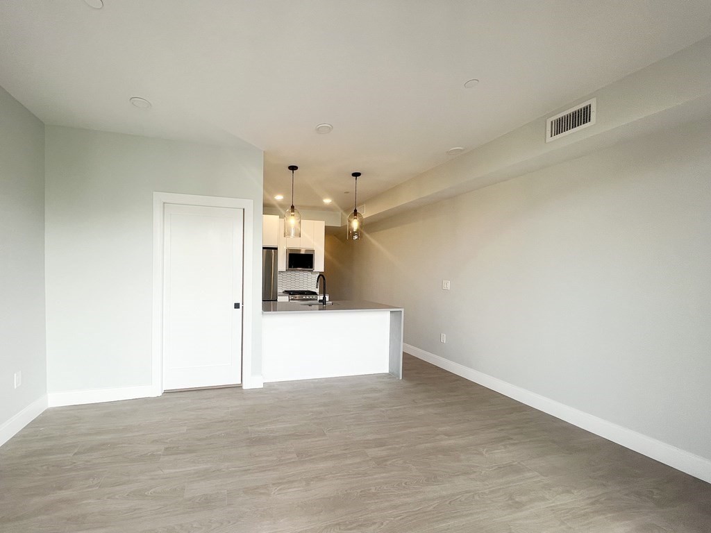 a view of a kitchen with a dishwasher and a refrigerator