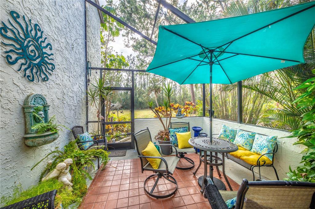 a view of an outdoor sitting area with chairs and backyard