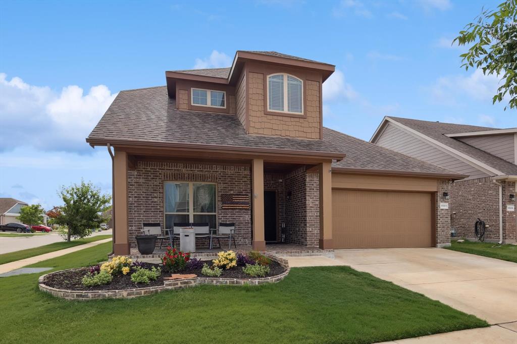 a front view of a house with a garden and plants