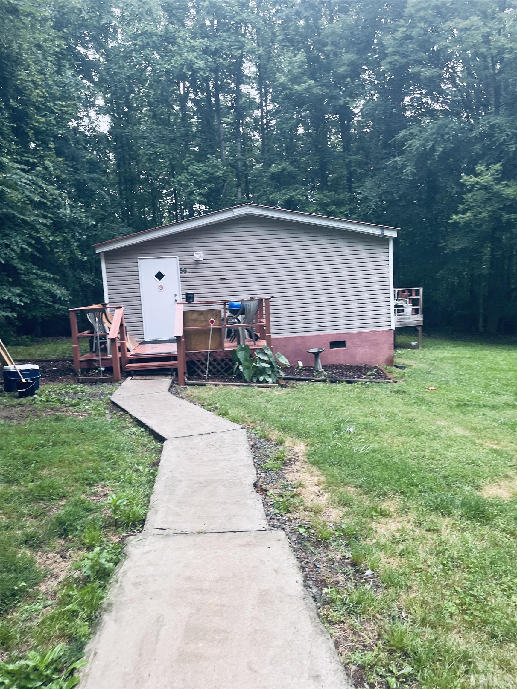 a front view of house with yard and trees