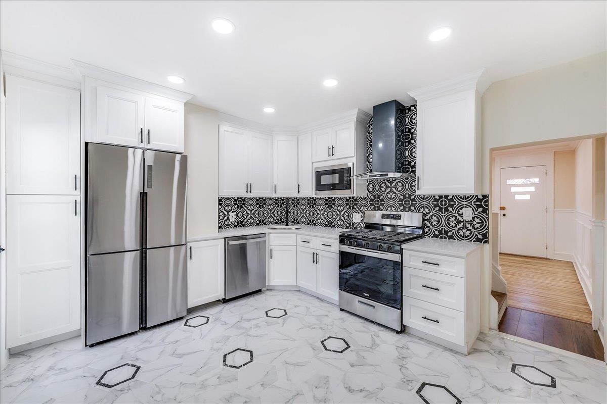 a kitchen with a refrigerator sink and stove