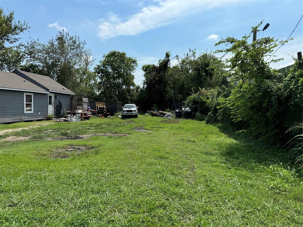 a view of a house with a yard and sitting area