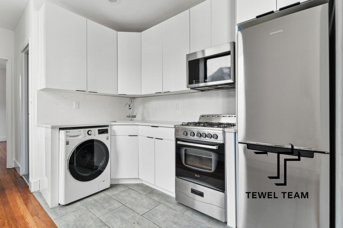 a utility room with sink dryer and washer