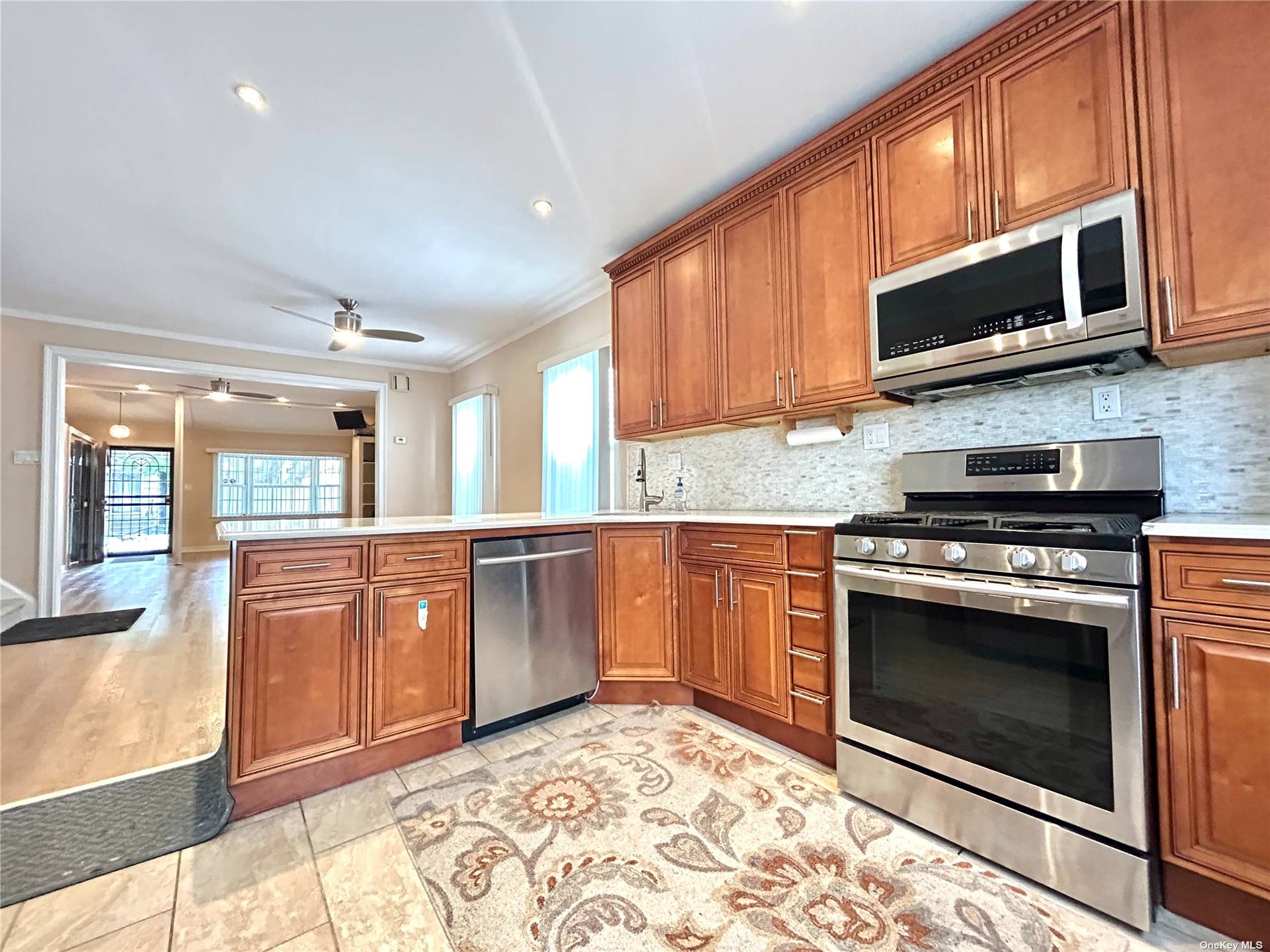 a kitchen with stainless steel appliances granite countertop a stove microwave and sink