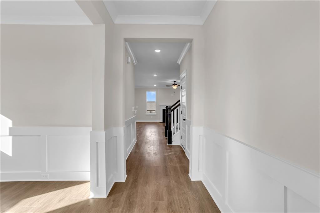 a view of a hallway with wooden floor