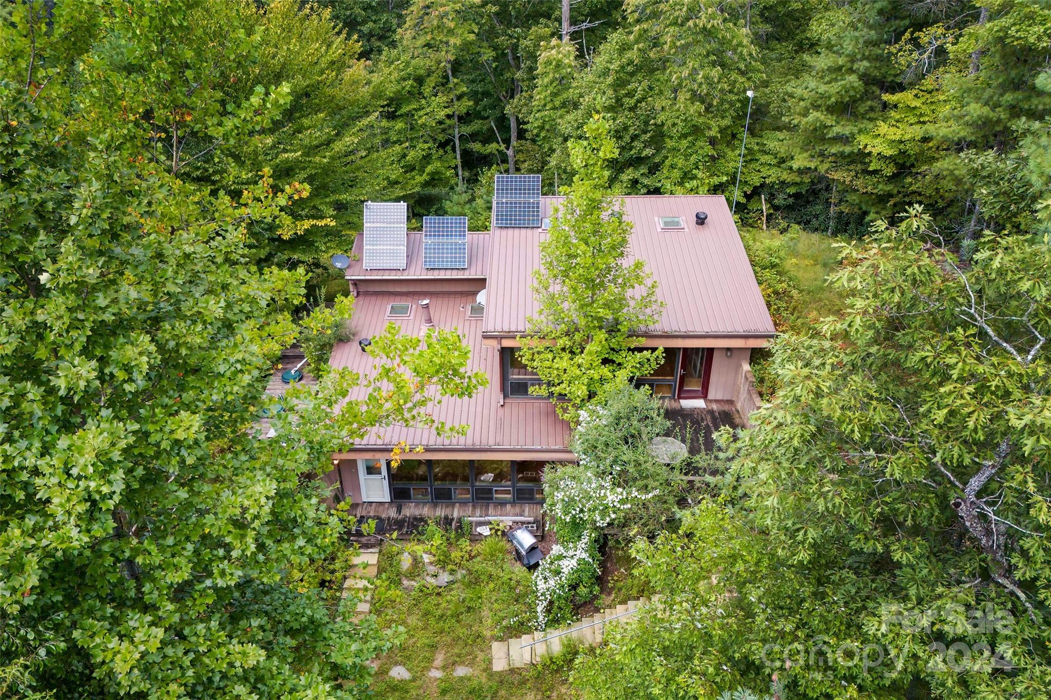 an aerial view of a house with swimming pool and garden