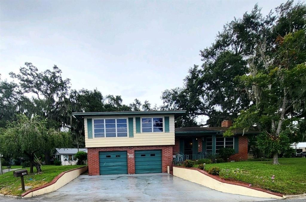 a front view of house with yard and green space