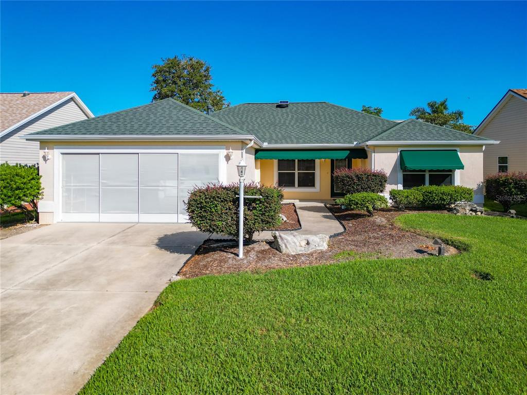 a front view of a house with a yard and porch