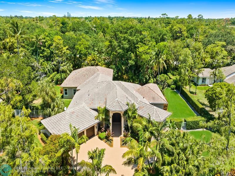 an aerial view of a house with yard swimming pool and outdoor seating