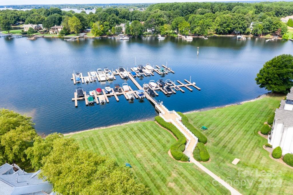 an aerial view of a house with a garden and lake view