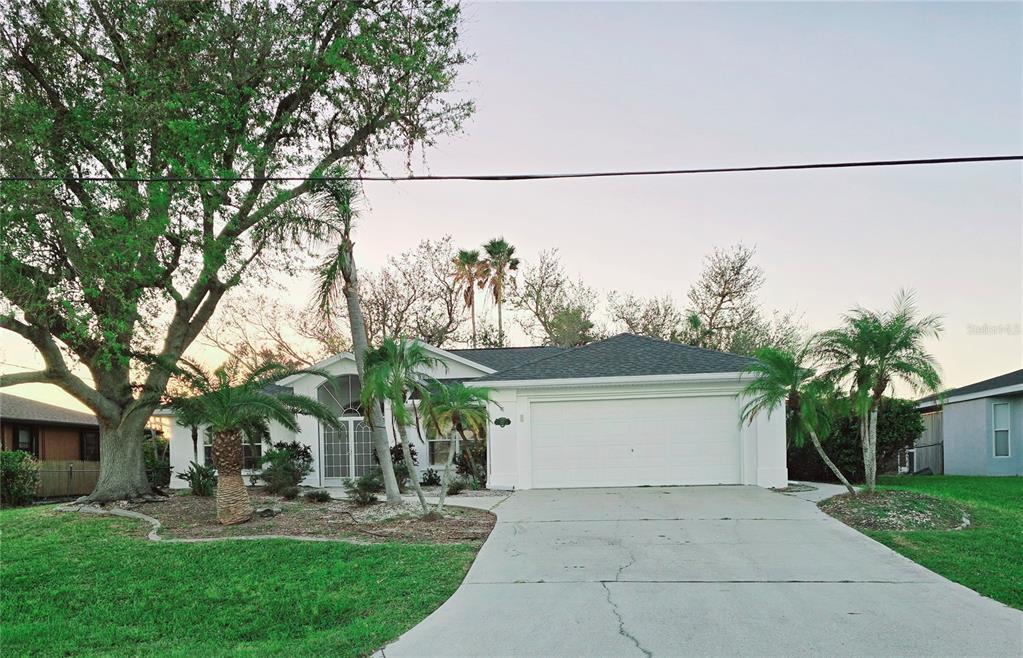 a view of a house with a yard and sitting area