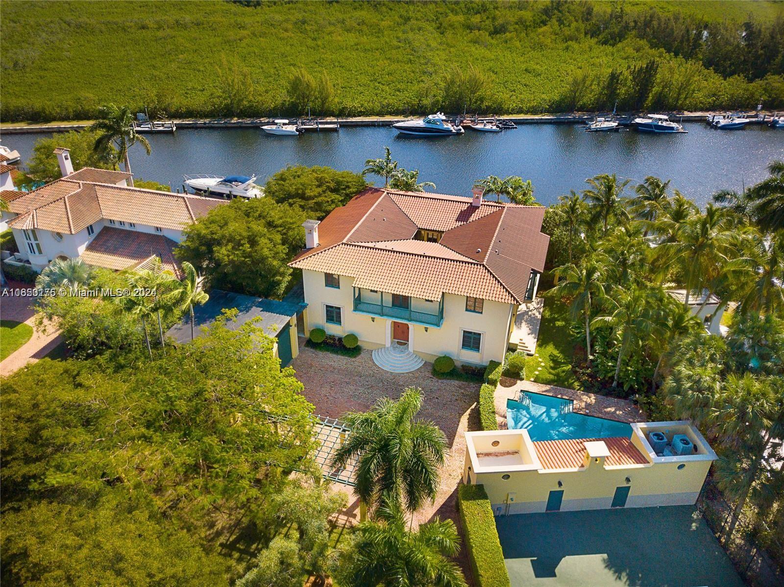 an aerial view of a house with a lake view