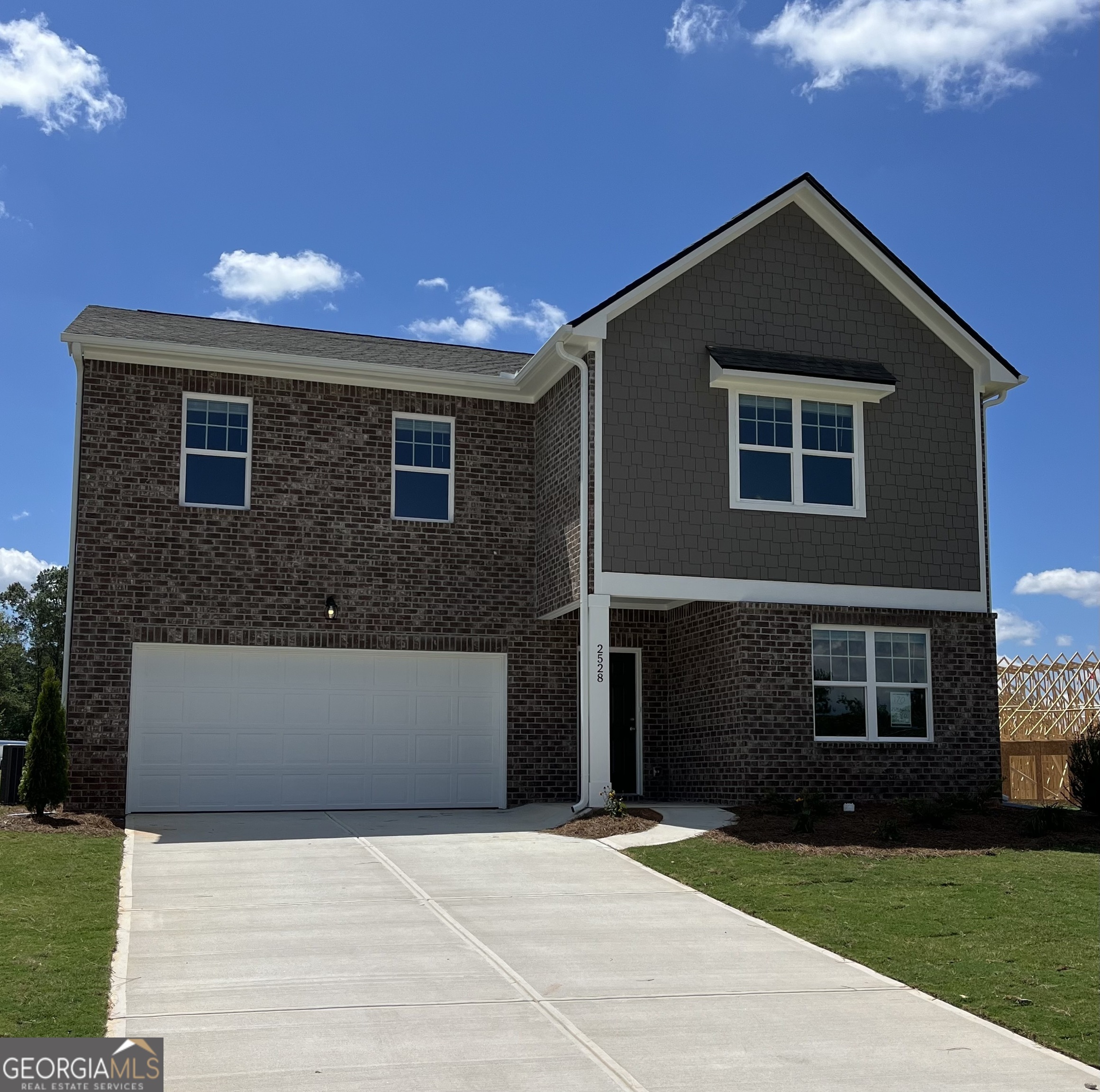 a front view of a house with yard