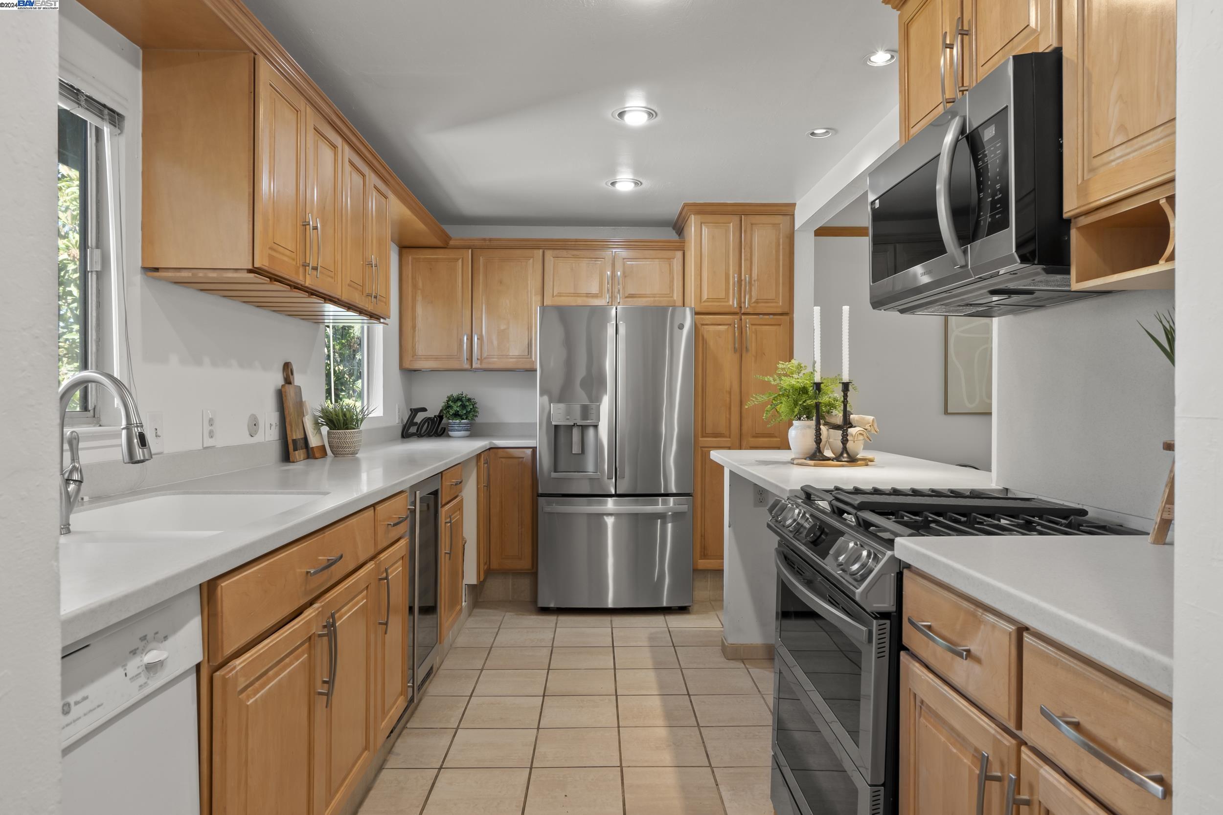 a kitchen with stainless steel appliances granite countertop a stove a refrigerator and a sink