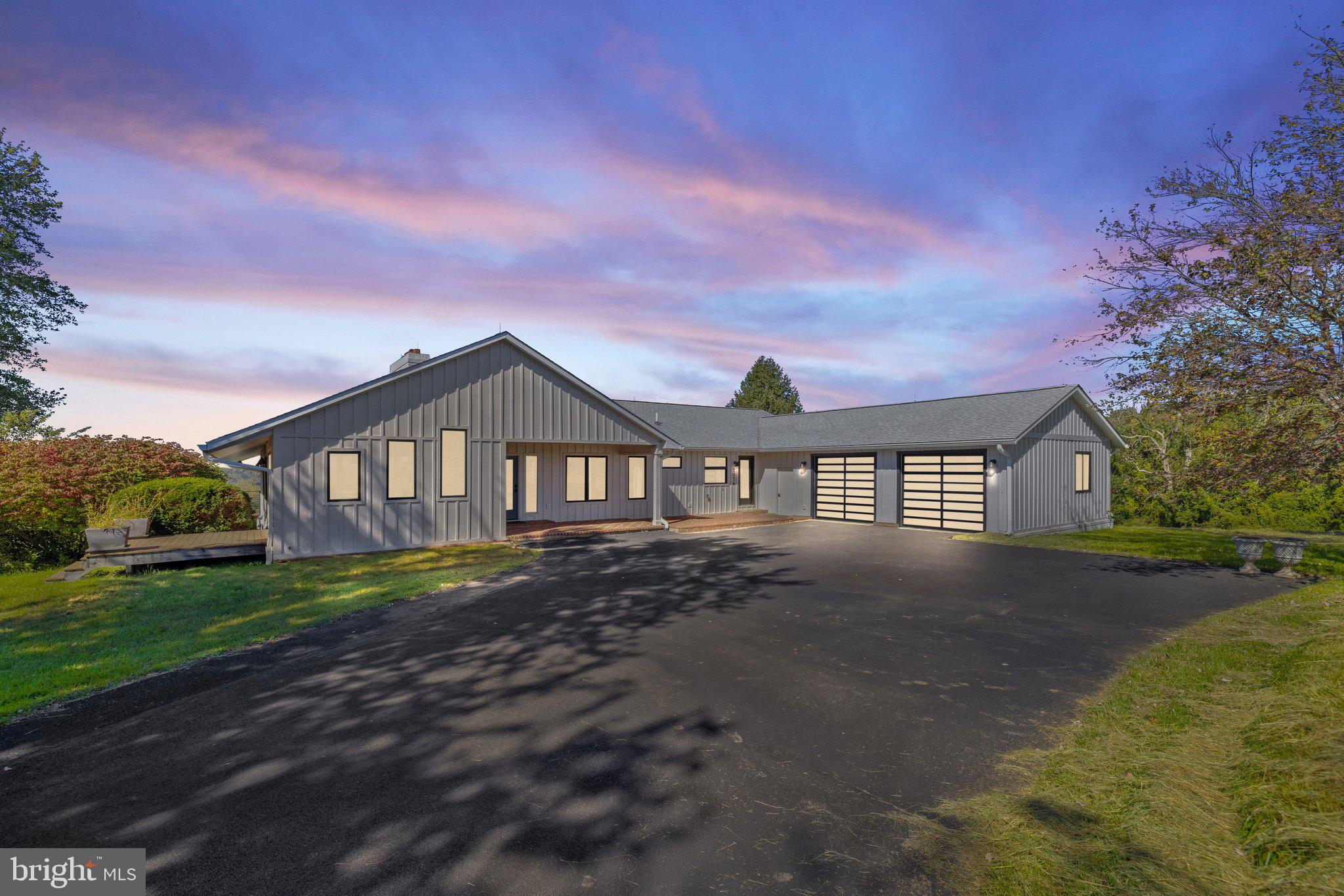 a front view of a house with yard and green space