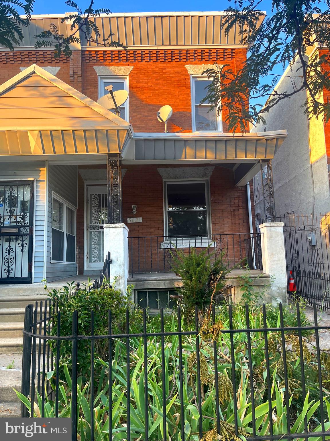 a view of a house with wooden fence