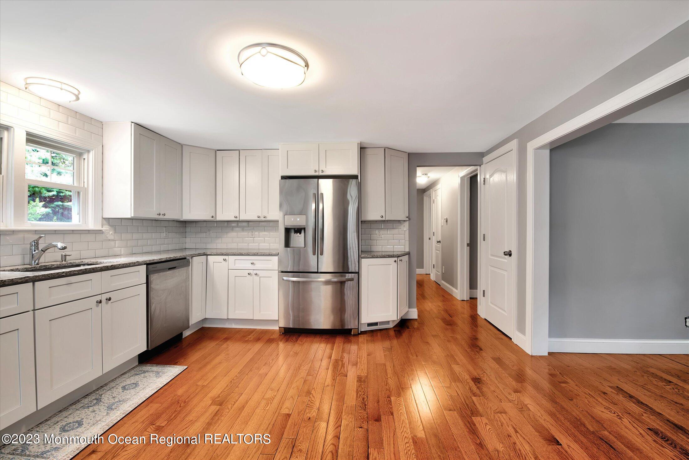 a kitchen with a refrigerator and a sink