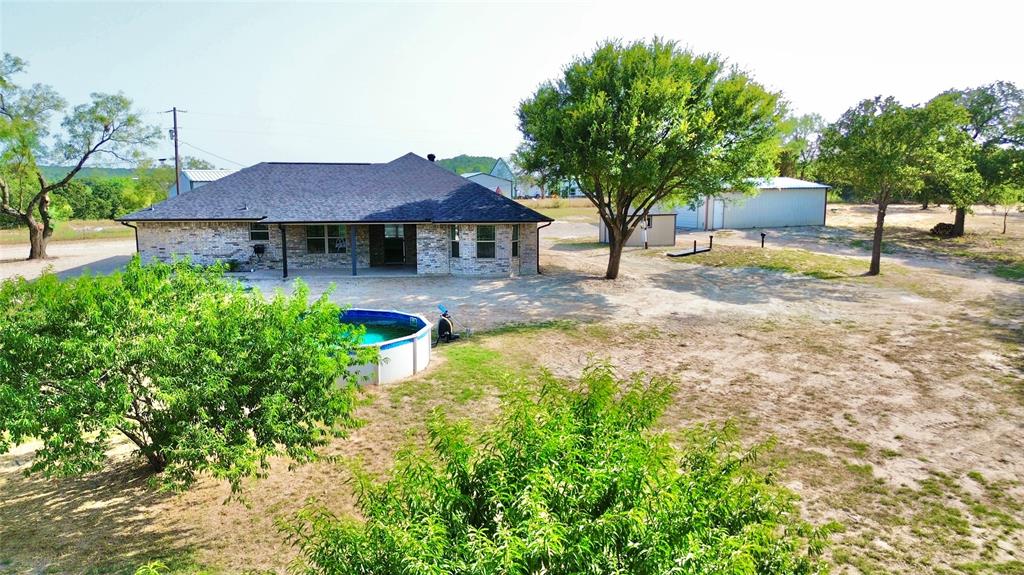 a view of a house with a yard and sitting area