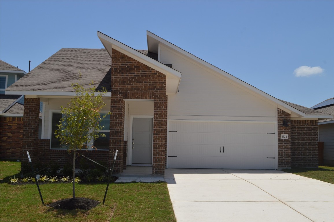 a front view of a house with sitting area