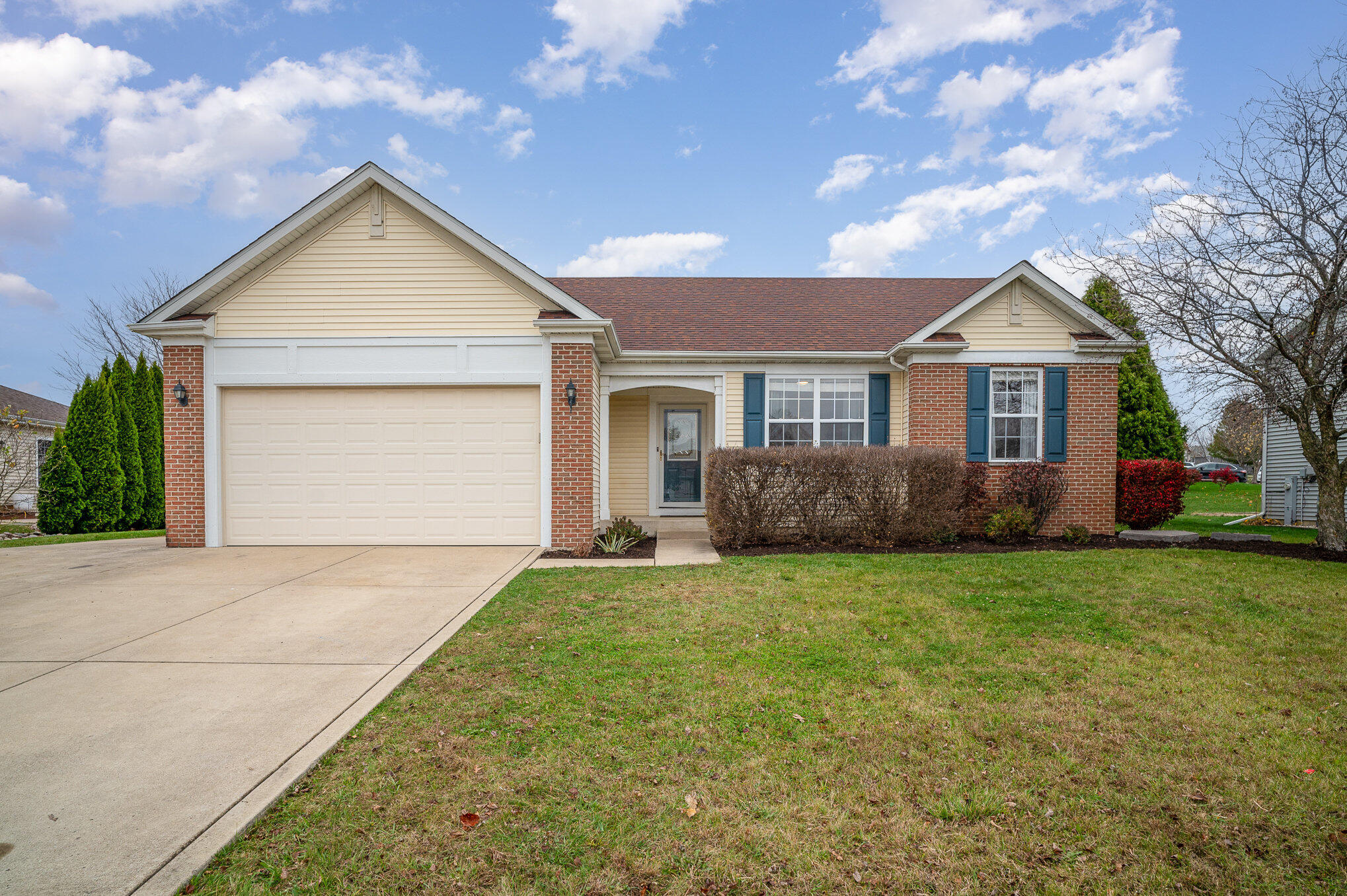 a view of a house with a yard and garage