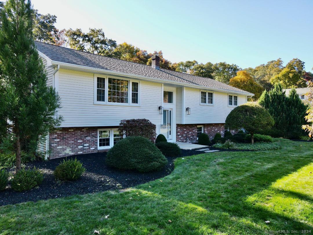 a view of a house with a yard and a garden