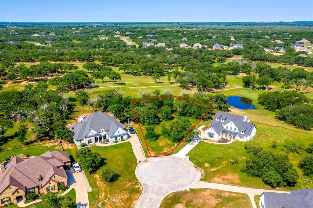 an aerial view of residential houses with outdoor space and swimming pool