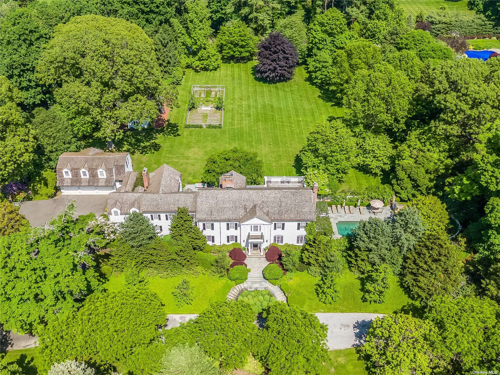 a aerial view of a house with a yard basket ball court and outdoor seating