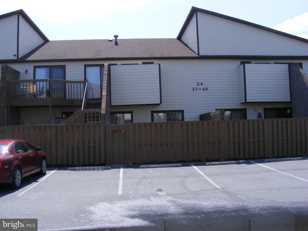 a front view of a house with a wooden fence