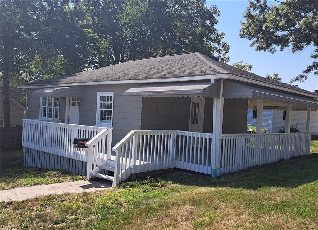 a view of a house with a yard and deck