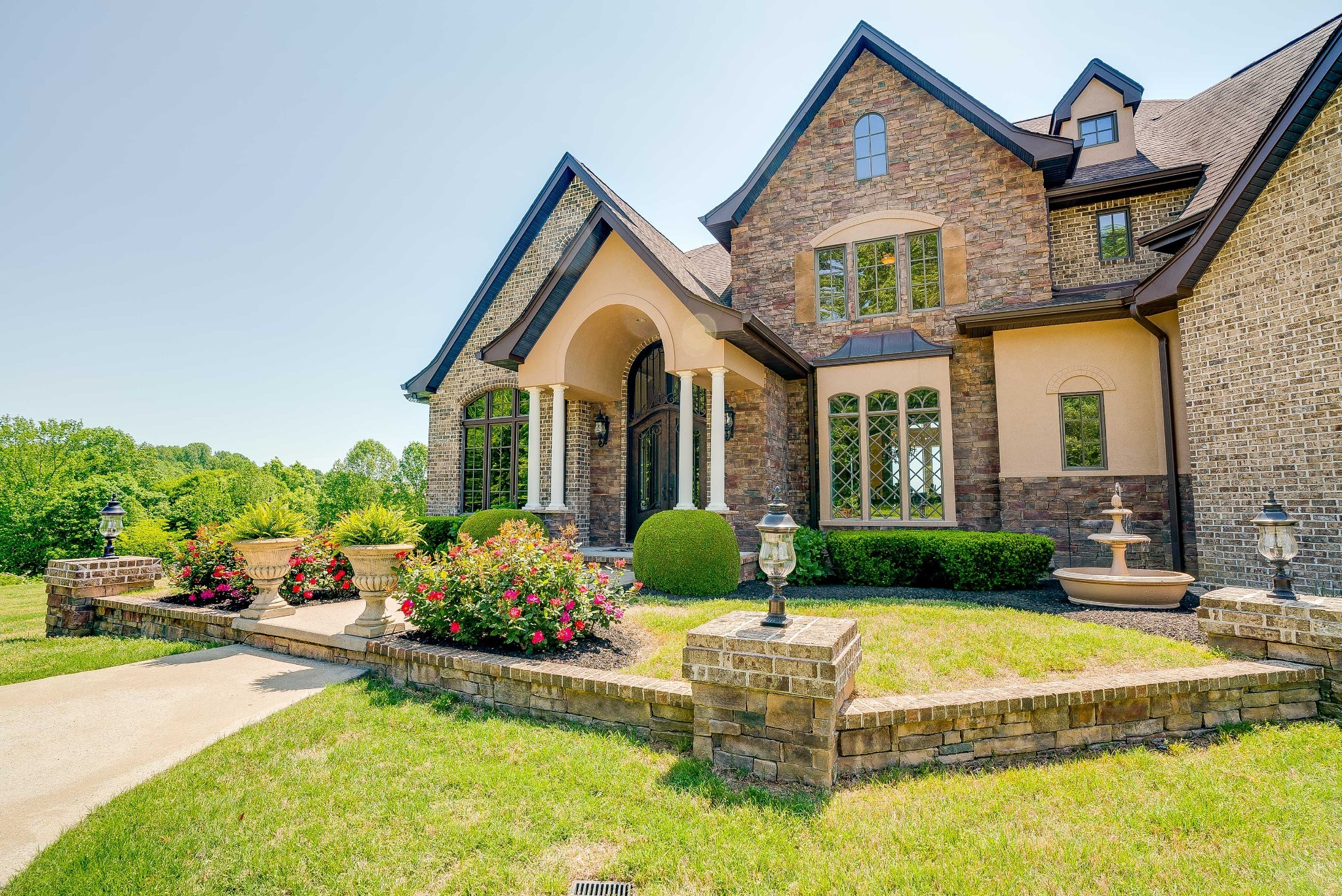 a front view of a house with garden and porch