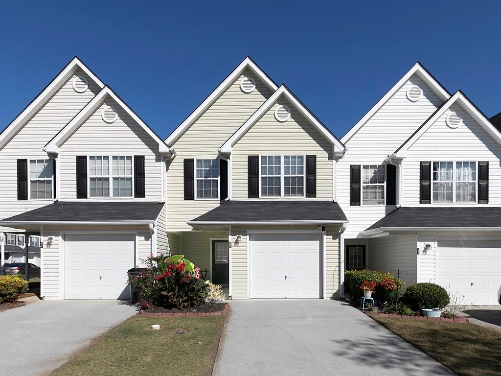 a front view of a house with a yard