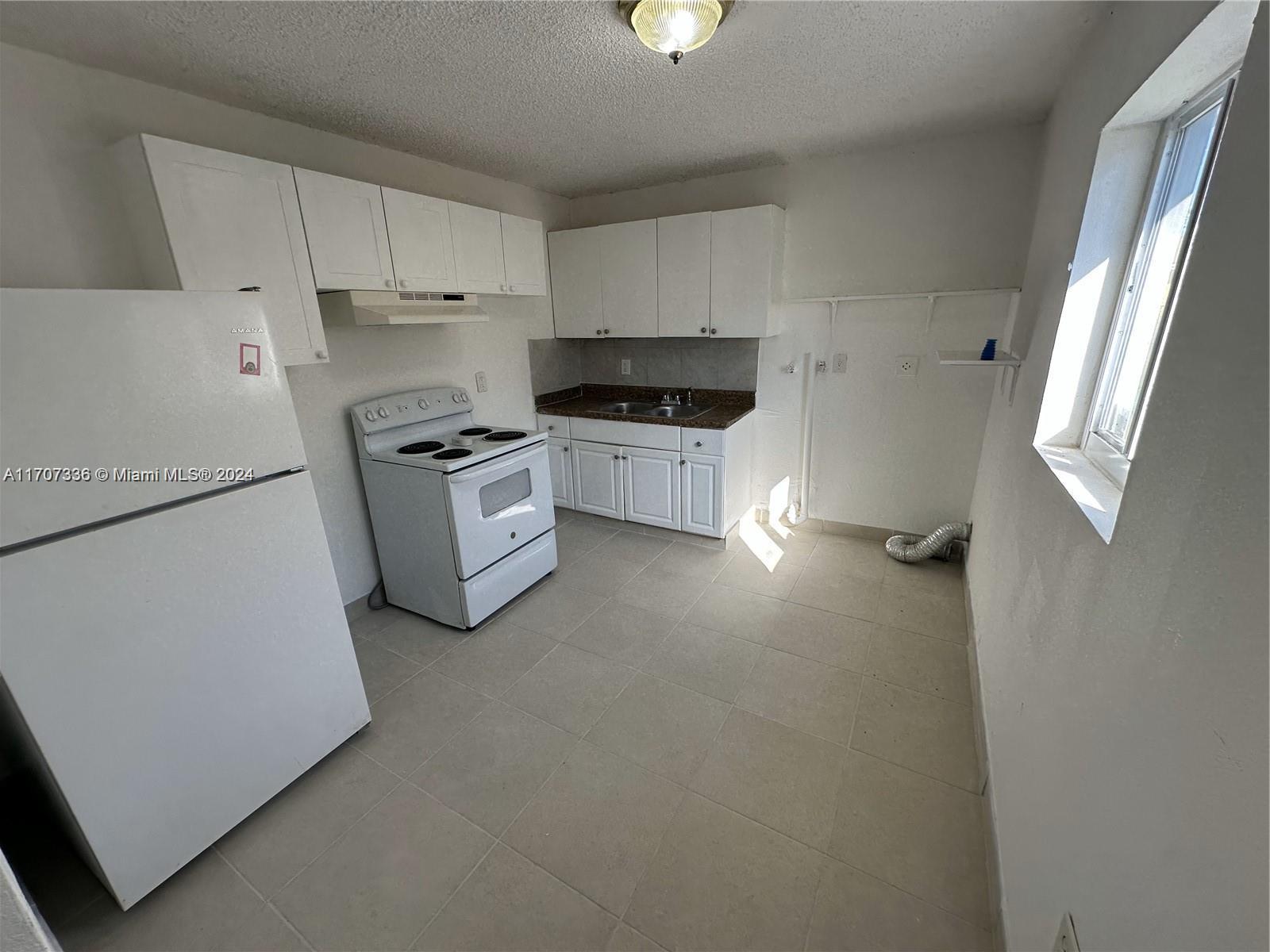 a kitchen with stainless steel appliances a refrigerator sink and stove