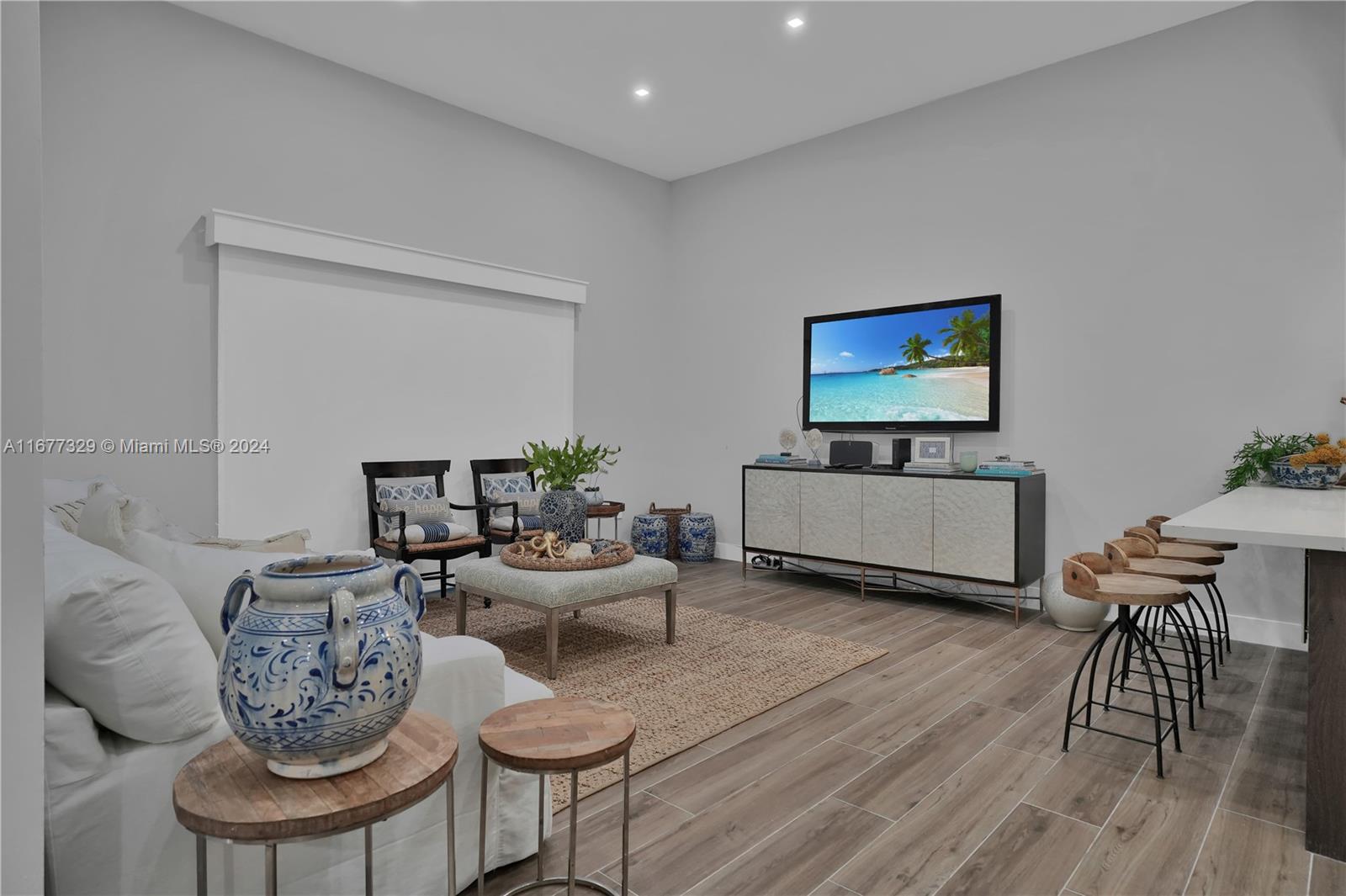 a living room with furniture and a flat screen tv