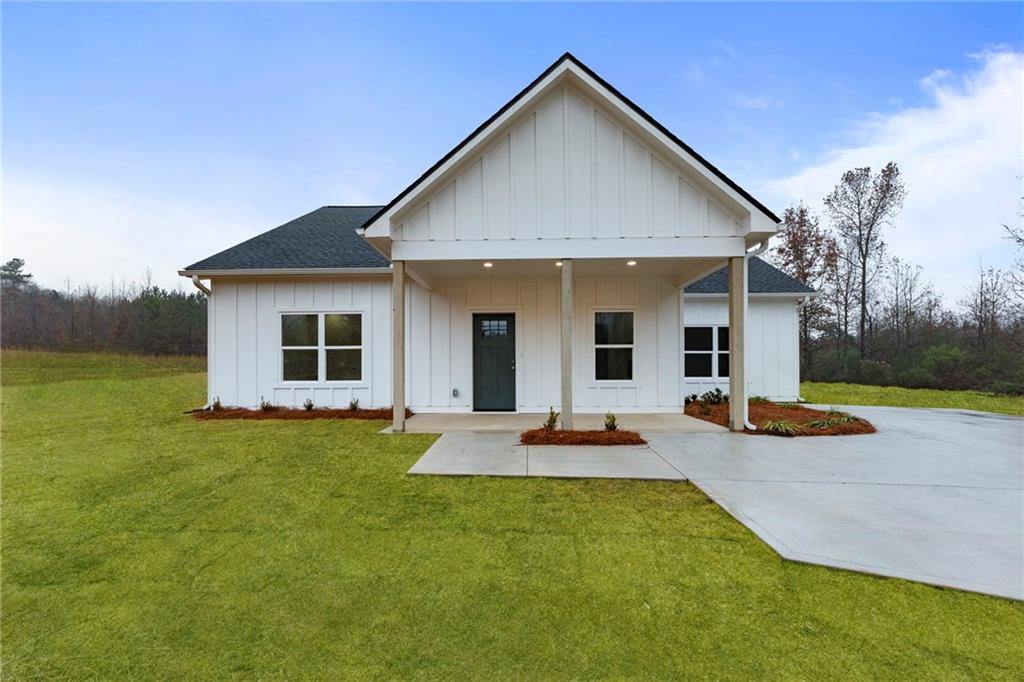 a front view of a house with patio and garden