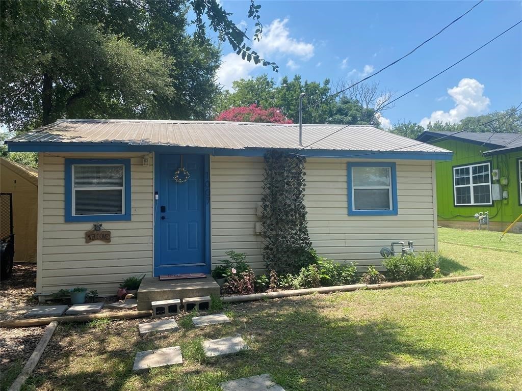 a front view of a house with garden