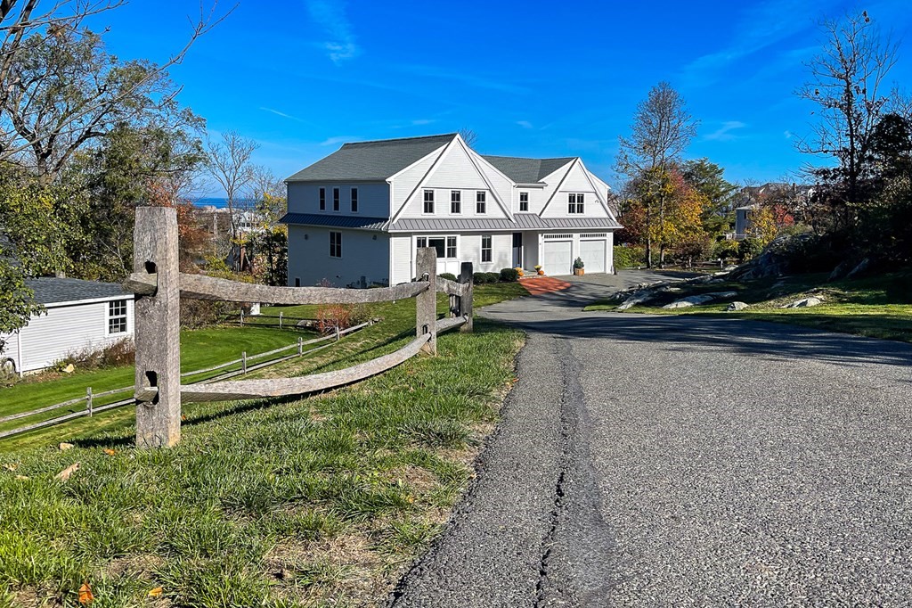 a view of house with a yard and a large tree