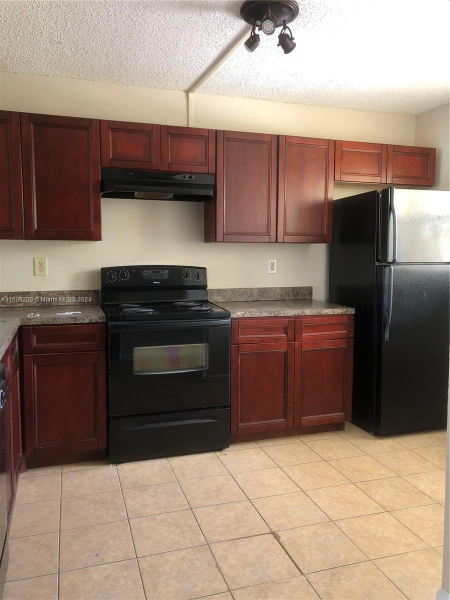 a kitchen with granite countertop a cabinets and steel stainless steel appliances