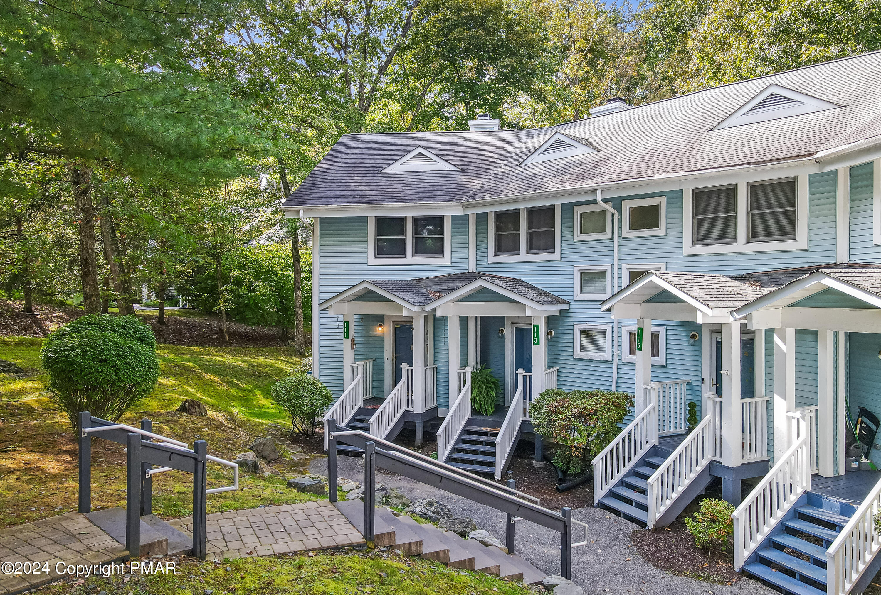 a front view of a house with yard porch and furniture