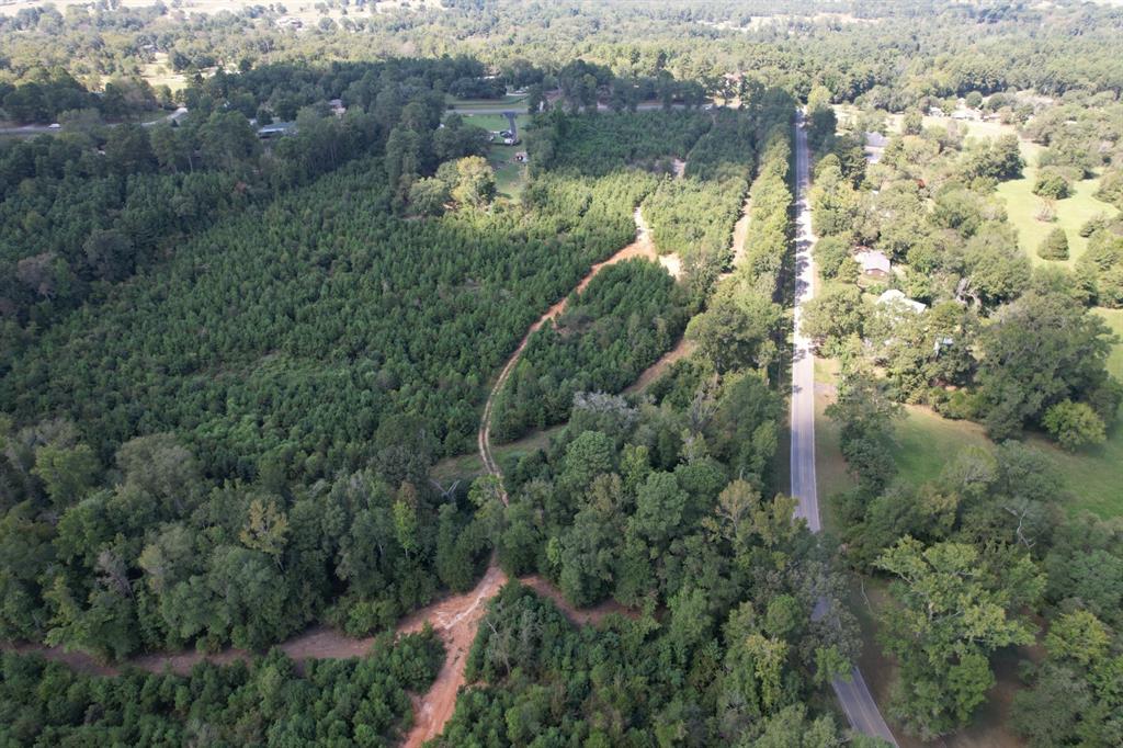 an aerial view of a house with a yard and lake view